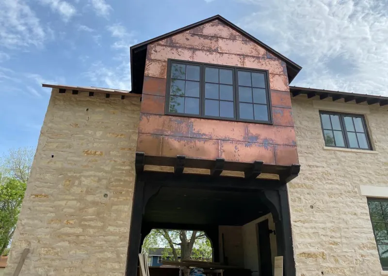 Copper metal panel facade on a stone building for Skylight Installation in East Haddam